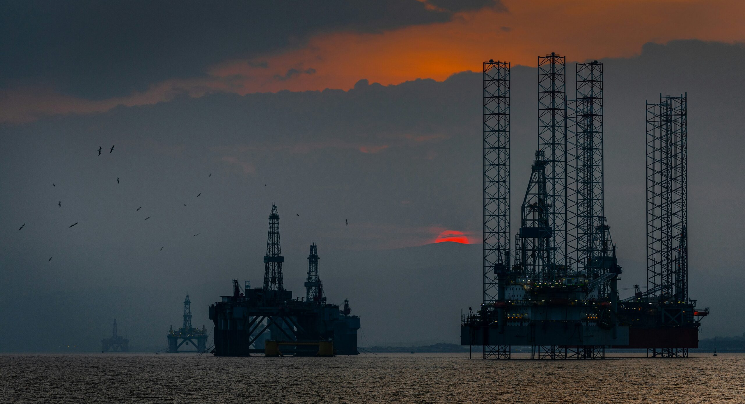 An oil rig at night in the sea