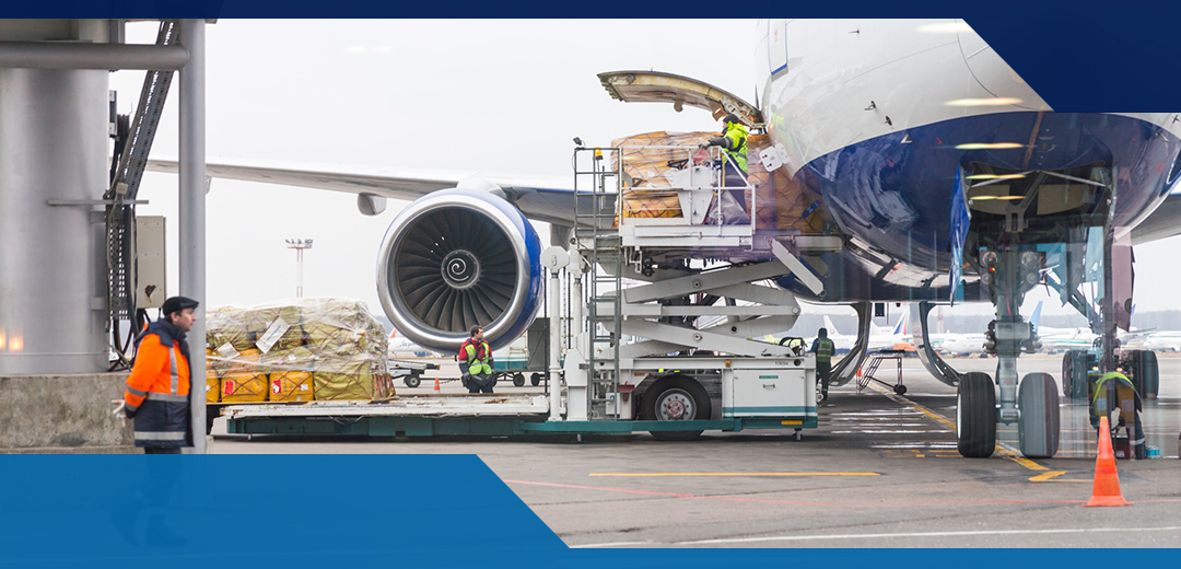 Airport workers load up cargo onto an airplane